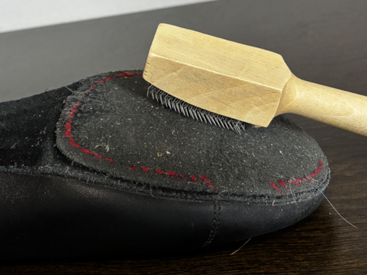 Using a metal wire brush to clean suede dance shoe soles